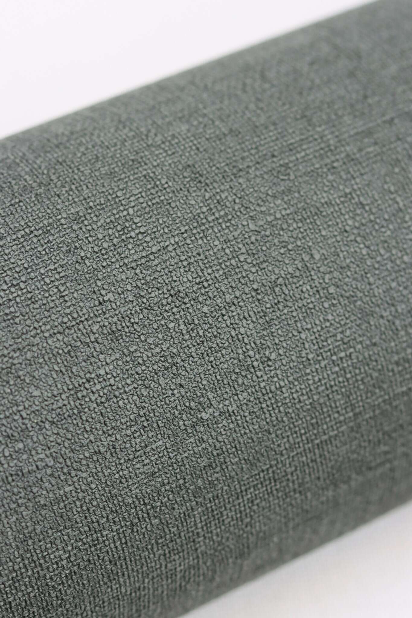 10-448627 Detailaufnahmen 3 Detailed image of Plain wallpaper in grey with a textile linen-like surface, ideal for cosy room designs.