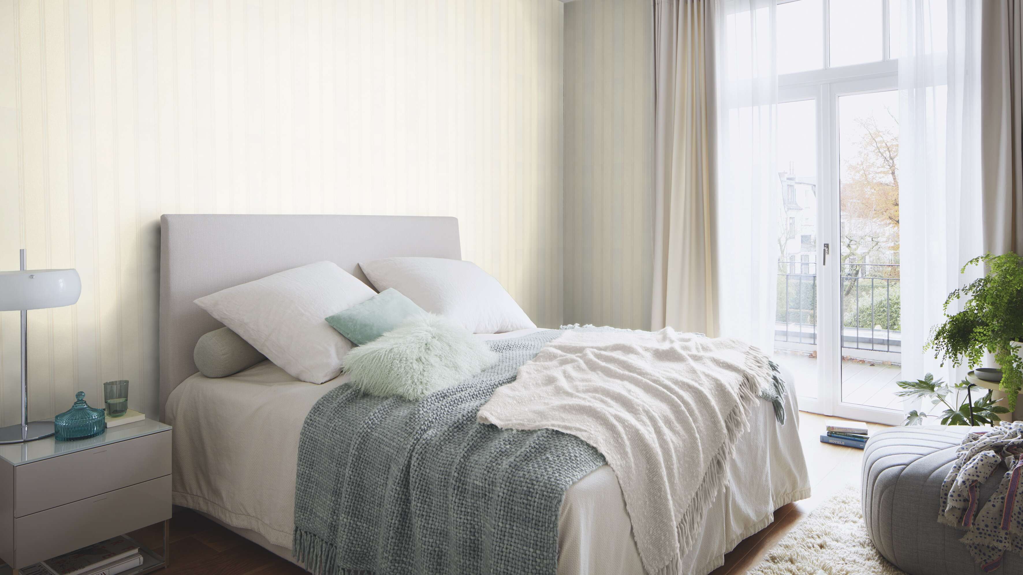10-421026 Raumsituationen 6 Room with Non-woven wallpaper with a fine, vertical striped pattern in various shades of beige.