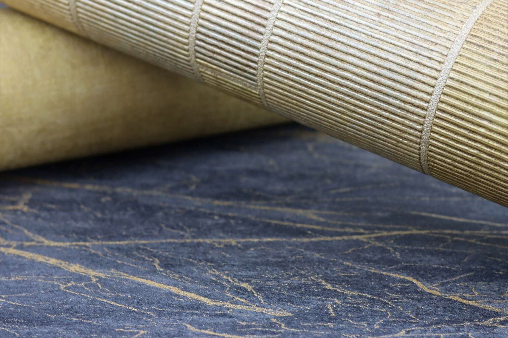 10-428964 Detailaufnahmen 2 Detailed image of Non-woven wallpaper in black marble look with irregular gold-coloured veining.