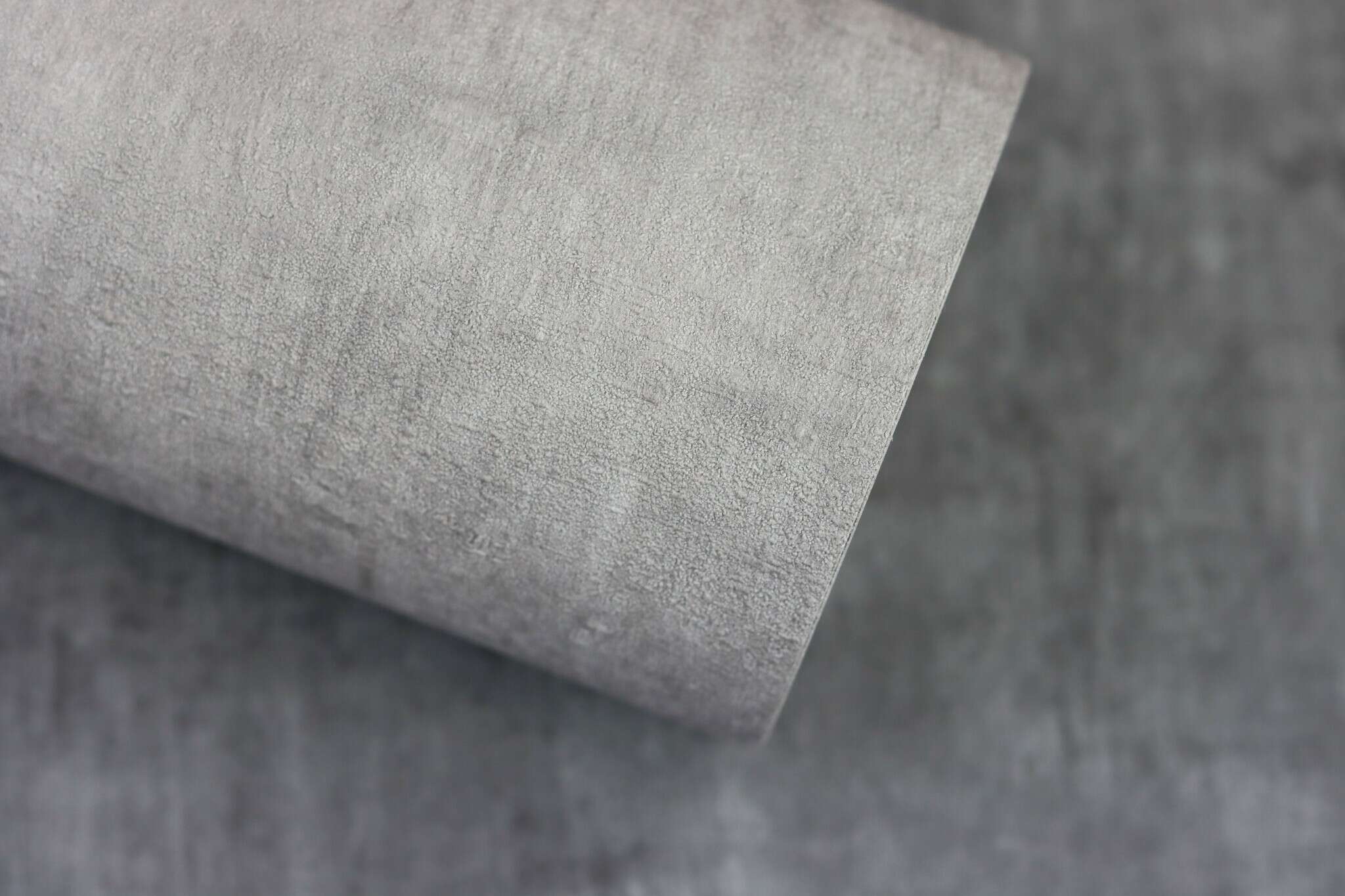 10-429237 Detailaufnahmen 33 Detailed image of Non-woven wallpaper with a textured surface in light grey.